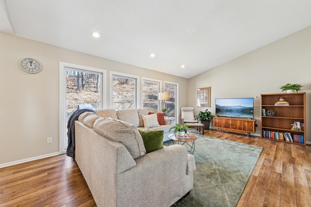 living room featuring recessed lighting, wood-type flooring, baseboards, and vaulted ceiling