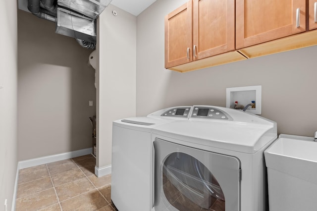 laundry room featuring cabinets, sink, independent washer and dryer, and light tile patterned flooring