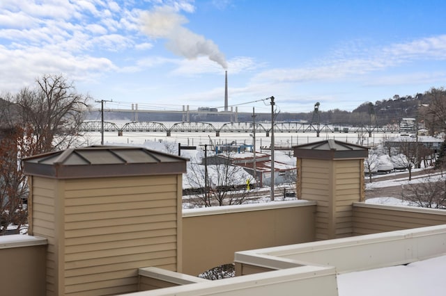 view of snow covered back of property