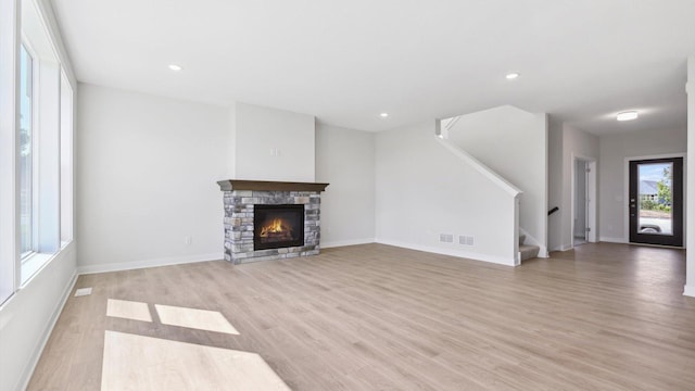 unfurnished living room featuring light hardwood / wood-style floors and a fireplace