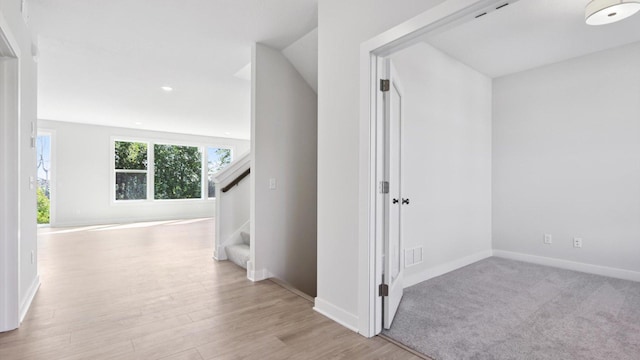 corridor with light wood-type flooring