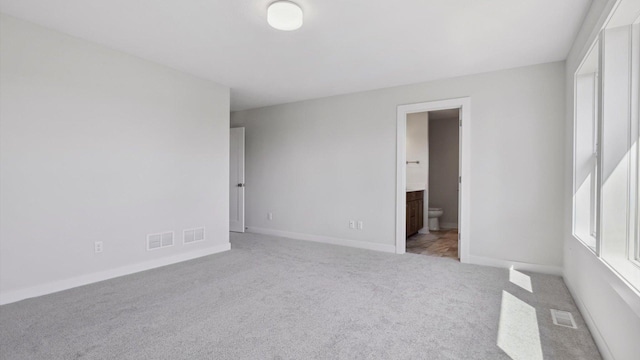 spare room featuring light colored carpet