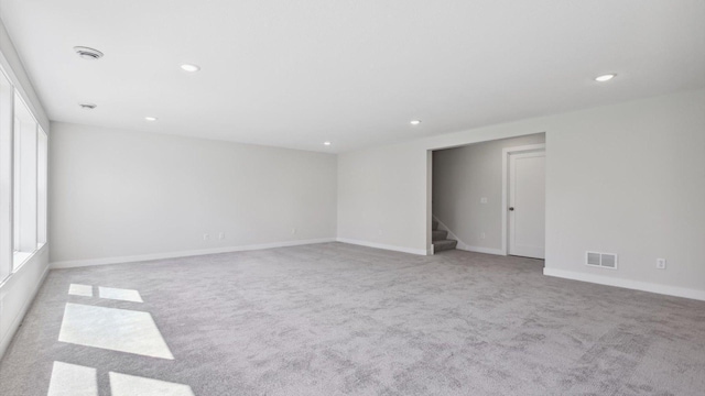 spare room with light colored carpet and plenty of natural light