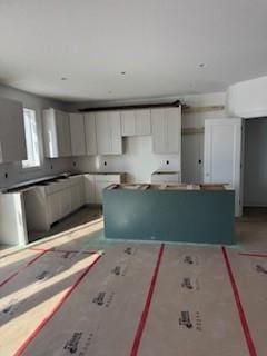 kitchen featuring white cabinets and a center island