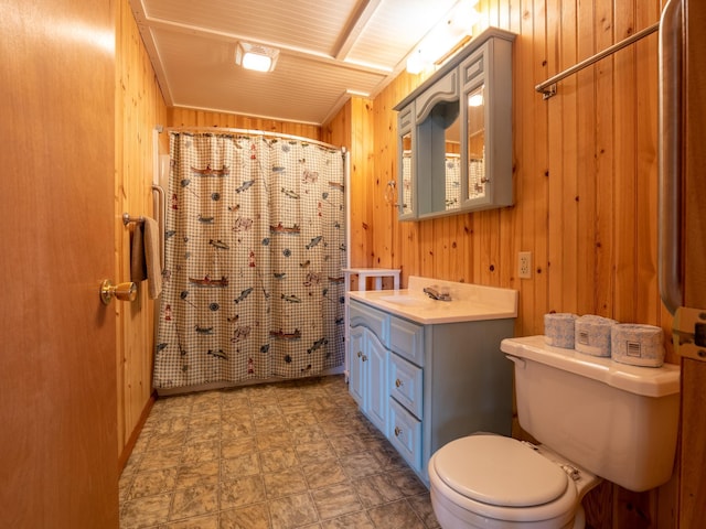 bathroom with toilet, vanity, wooden walls, and curtained shower