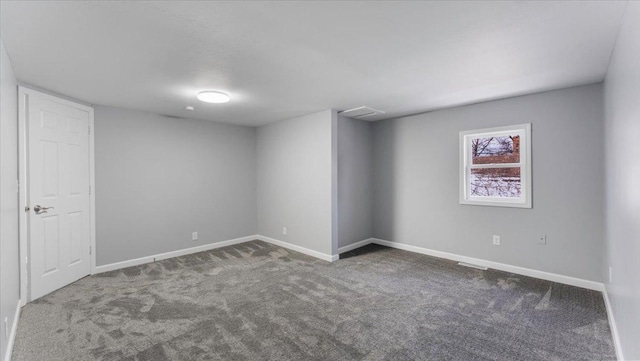 unfurnished room featuring dark carpet