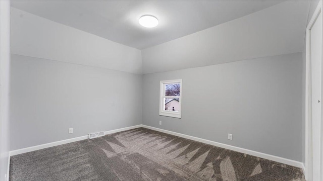 bonus room with vaulted ceiling and carpet