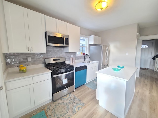 kitchen with sink, stainless steel appliances, and white cabinetry