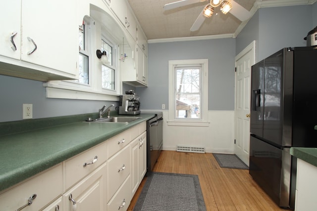 kitchen featuring sink, ornamental molding, black appliances, white cabinets, and light wood-type flooring