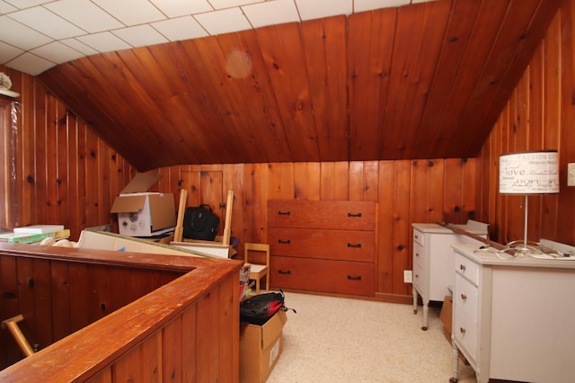 home office featuring light carpet, wooden walls, wooden ceiling, and lofted ceiling