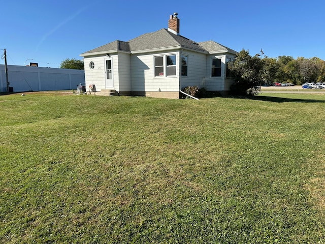 back of house featuring a yard