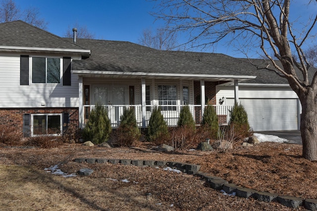 split level home featuring a garage and covered porch