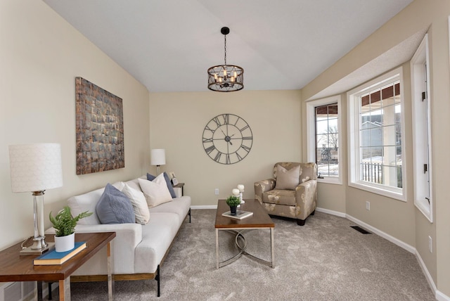 living room featuring light colored carpet and a notable chandelier