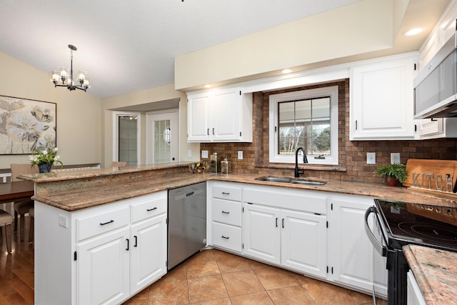 kitchen with dishwasher, sink, white cabinets, and kitchen peninsula