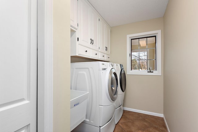 laundry area with cabinets, sink, washing machine and clothes dryer, and a textured ceiling