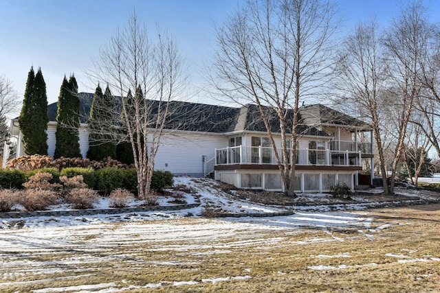 snow covered property with a balcony