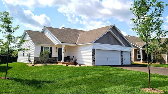 view of front of house with a garage and a front lawn