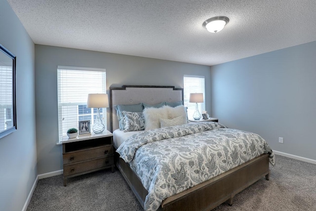 bedroom featuring carpet flooring and a textured ceiling