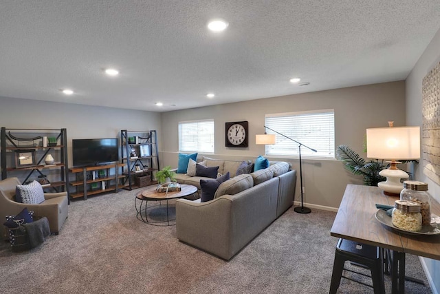 carpeted living room featuring a textured ceiling