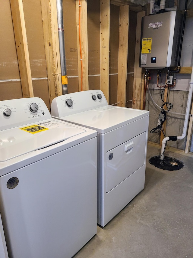 laundry area with water heater and washer and dryer