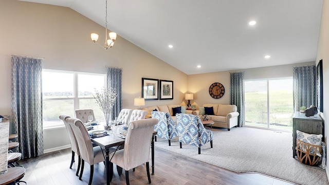 dining area featuring light wood-type flooring, vaulted ceiling, and a notable chandelier