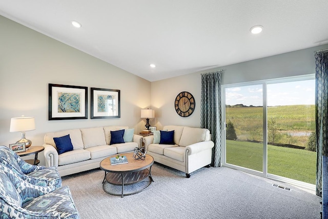 carpeted living room featuring lofted ceiling