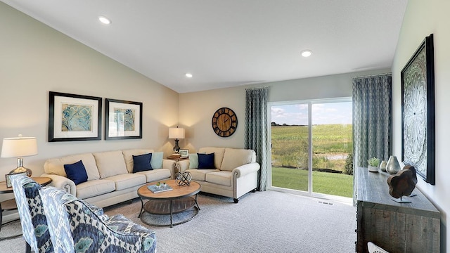 carpeted living room with vaulted ceiling