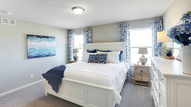 bedroom with a textured ceiling and carpet flooring