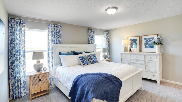 bedroom with a textured ceiling and carpet floors