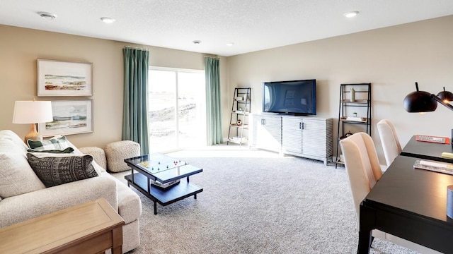 carpeted living room featuring a textured ceiling