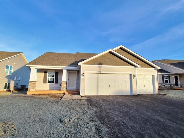 craftsman-style house with a garage and central air condition unit