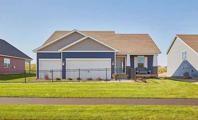 view of front of home featuring a porch, a garage, central AC unit, and a front lawn