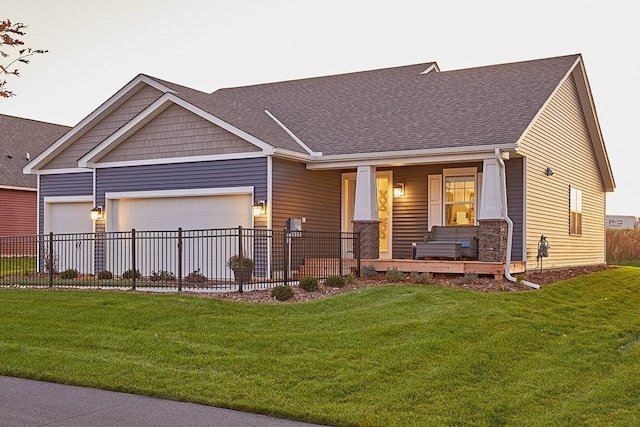 craftsman-style house with a garage, covered porch, and a front lawn