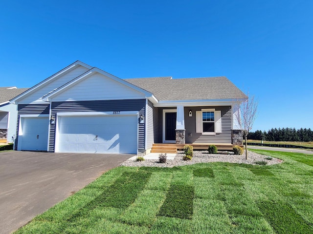 view of front of house with a front yard and a garage