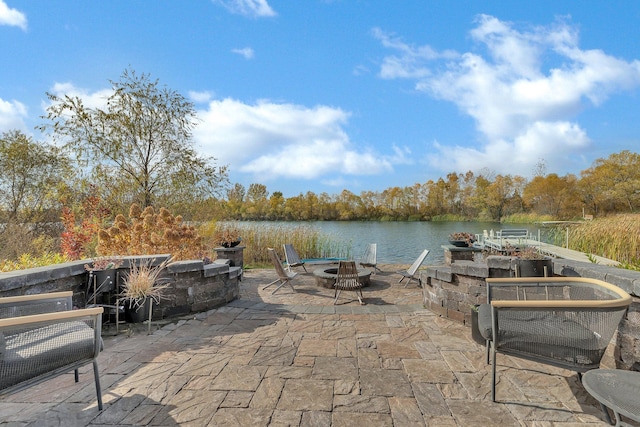 view of patio featuring a fire pit and a water view