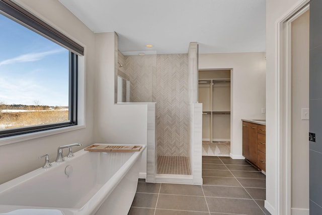 bathroom featuring tile patterned floors, separate shower and tub, and vanity