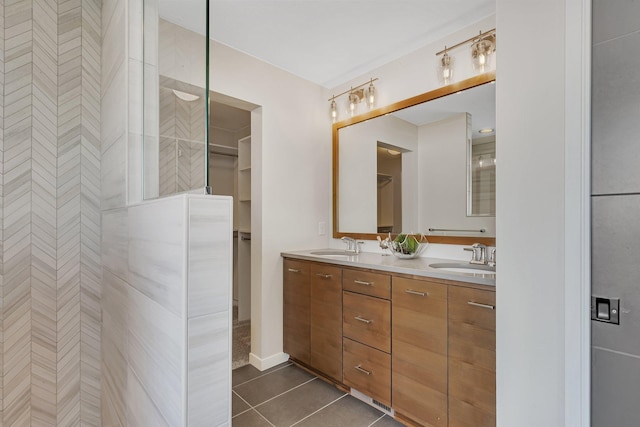 bathroom featuring tile patterned floors, vanity, and tiled shower