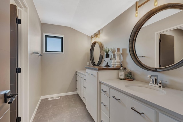 bathroom featuring lofted ceiling, tile patterned floors, and vanity