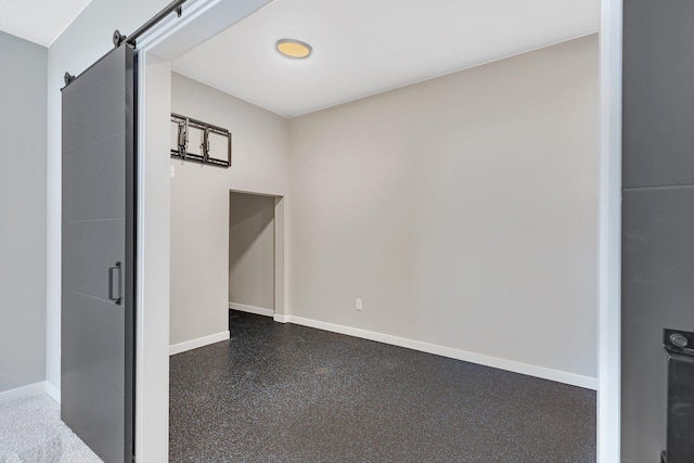 spare room featuring a barn door