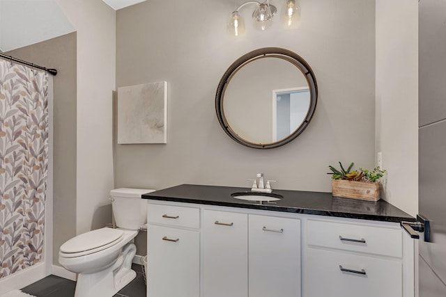 bathroom with toilet, walk in shower, tile patterned floors, and vanity