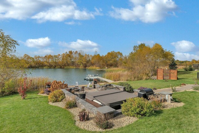 view of storm shelter with a yard and a water view