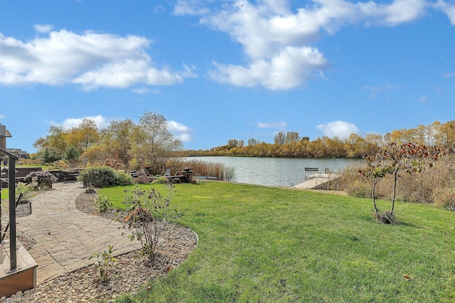 view of yard featuring a water view and a boat dock