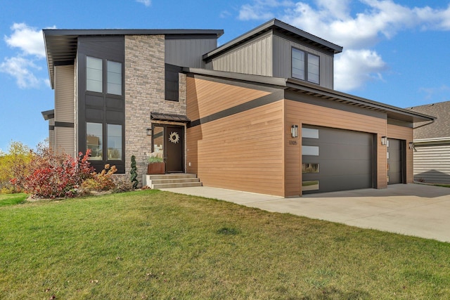 contemporary house with a garage and a front lawn