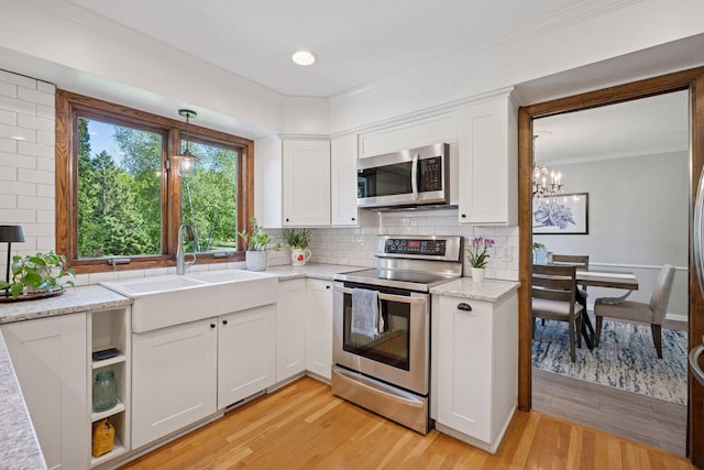 2500 Urbandale Ln N, Plymouth, MN 55447 - kitchen with appliances with stainless steel finishes, light wood-type flooring, white cabinets, ornamental molding, and tasteful backsplash