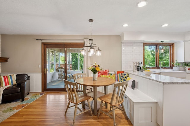 2500 Urbandale Ln N, Plymouth, MN 55447 - dining space featuring healthy amount of natural light, light wood-type flooring, wainscoting, a chandelier, and recessed lighting