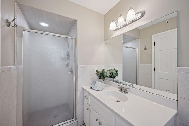 2500 Urbandale Ln N, Plymouth, MN 55447 - full bathroom featuring tile walls, a shower stall, vanity, and wainscoting