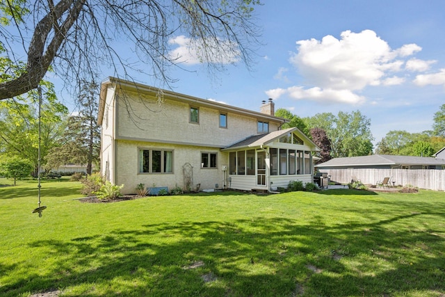 2500 Urbandale Ln N, Plymouth, MN 55447 - rear view of house with a chimney, a sunroom, and stucco siding