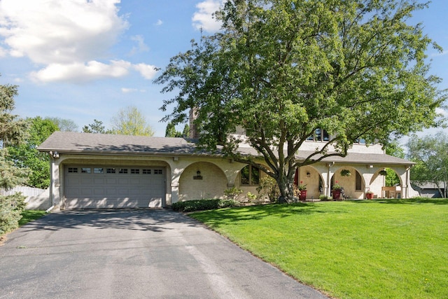 2500 Urbandale Ln N, Plymouth, MN 55447 - view of front of home featuring asphalt driveway, a front yard, a garage, and covered porch