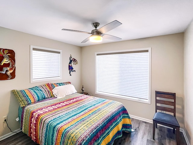 bedroom with dark hardwood / wood-style floors and ceiling fan