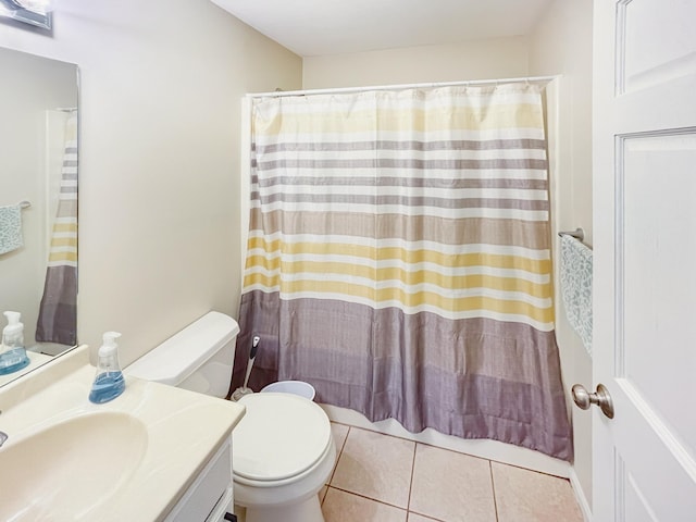 bathroom with tile patterned flooring, vanity, and toilet